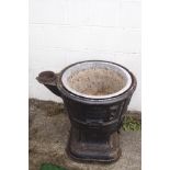 A cast iron log boiler converted into a planter,