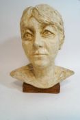 A contemporary plaster bust of a lady, upon a wooden base,