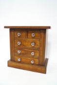 A mahogany table top chest of five drawers,