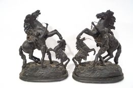 A pair of Spelter figures of Marley horses, each on oval ebonised bases with turned ball feet,
