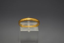 A 22ct gold wedding band, 3.