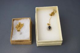 A 9 carat gold sapphire and diamond cluster pendant,