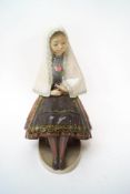 A Lladro Daisa figure of a seated girl wearing a head shawl, 26cm high,
