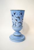 A Victorian milk glass vase, hand painted with wild flowers and a butterfly over a blue ground,