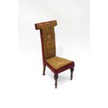 A Victorian rosewood pre dieu with original tapestry and red velvet upholstery