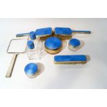 A matched blue guilloche enamel dressing table set, by Adie Brothers, Birmingham 1938 and 1939,