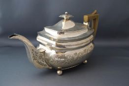 A George III silver teapot, London 1812, makers mark indistinct, of rounded rectangular outline,