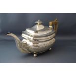 A George III silver teapot, London 1812, makers mark indistinct, of rounded rectangular outline,