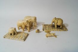 Five pre-1947 carved ivory figures of elephants, two on rectangular ivory bases,