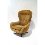 A 1970s Swedish swivel armchair in striped brown fabric,