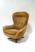 A 1970s Swedish swivel armchair in striped brown fabric,