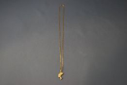 A 9 carat gold chain, of filed curb links, 45 cm long, and a Nefertiti charm attached, 3.