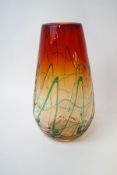 A contemporary French art glass vase, with green linear design against an amber and red ground,