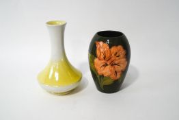 A Moorcroft vase with hibiscus pattern over a green ground, impressed marks, 13cm high,