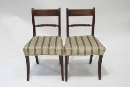 A pair of 19th century mahogany rope back dining chairs with upholstered seats and standing on