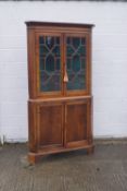 A George III oak corner cabinet with later additions,