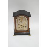 A mahogany three train chimney mantel clock, with silvered face,