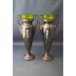 A pair of WMF electroplated two handled vases, with green glass liners, marks to underside,