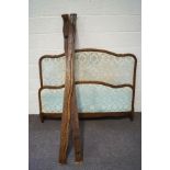French style double bed with patterned upholstered head and foot boards,
