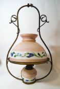 A Victorian hanging oil lamp with glass reservoir and shade, painted with flowers on a pink ground,