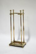 A Victorian brass stick/umbrella stand with inset tile to base,