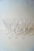 A set of eight cut glass champagne flutes,