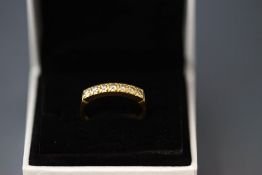 A seven stone diamond 18 carat gold half-eternity ring,