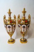 A pair of two handled Royal Crown Derby pedestal vases, Imari 1128 pattern,