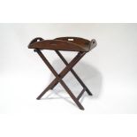 An early 20th century oak butler's tray and a folding stand,