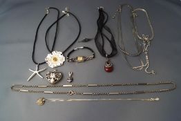 A collection of silver and silver coloured jewellery with watch