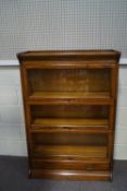 A Globe Wernicke style oak three tier bookcase, with drawer to base,