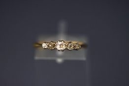 An early 20th century gold and diamond five stone ring, the graduated old-cut stones approx 0.