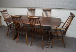 A set of six Ercol stick back dining chairs and an Ercol refectory style table,