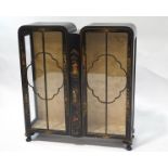 An early 20th century double fronted display cabinet, with lacquered Japanese style decoration,