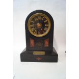 A Victorian black slate presentation mantel clock, with two train movement,