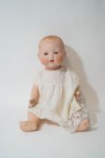 An early 20th century Armand Marseille doll, the bisque head with open mouth and rolling eyes,