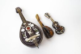 A miniature tortoiseshell and mother of pearl guitar, 12cm long, a similar miniature lute,
