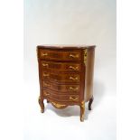 A reproduction French style serpentine chest of drawers,