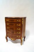 A reproduction French style serpentine chest of drawers,