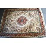 A Wilton carpet with central medallion to a beige field surrounded by trees,