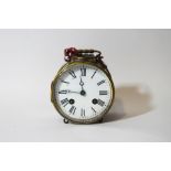 A brass drum alarm clock with visible escapement, 13cm high including handle,