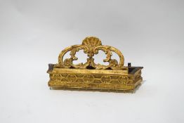 A carved giltwood pelmet with scroll and shell crest,
