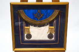A Masonic apron, in glazed frame, overall 48cm x 52.