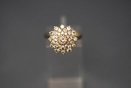 An 18 carat gold and diamond cluster ring, the round brilliants approx 1.
