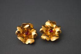 A pair of Egyptian gold flower clip earrings, set with a cabochon to the centre, 2.