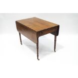 A Victorian mahogany Pembroke table, with single drawer and dummy drawer, upon ring turned legs,