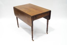 A Victorian mahogany Pembroke table, with single drawer and dummy drawer, upon ring turned legs,