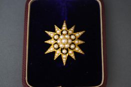 A Victorian seed pearl starburst pendant brooch, 2.9 cm across, 7.