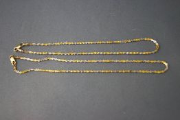 A 14 carat white and yellow gold anklet,