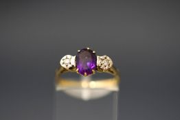 An amethyst and illusion set diamond three stone ring, stamped '18ct', finger size O, 2.
